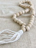 handcarved wooden farmhouse beads on tan canvas