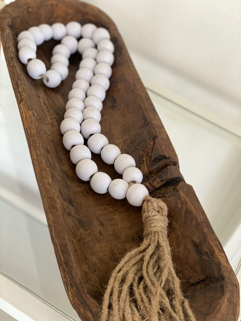 handmade white wooden farmhouse beads with jute tassel styled in natural brown dough bowl